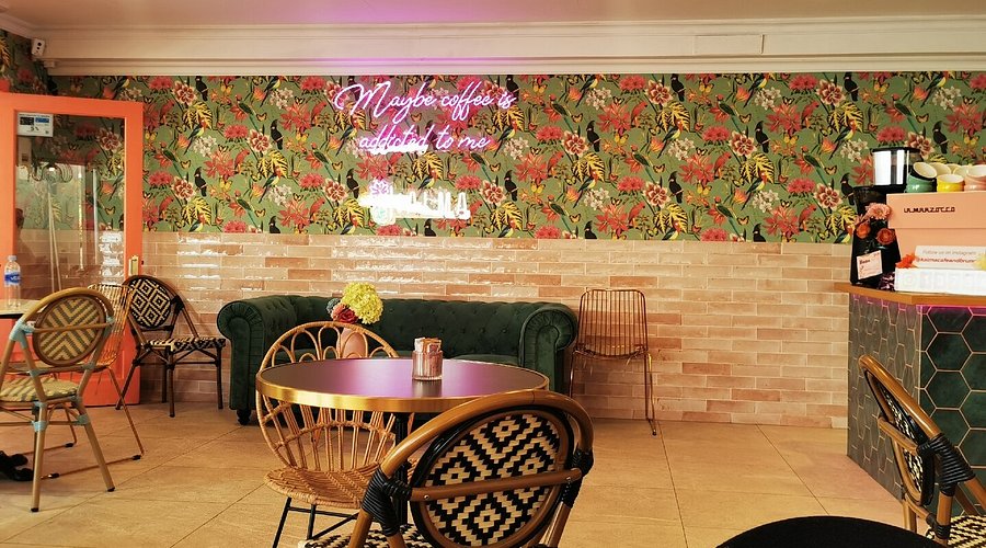 Cozy cafe terrace with rattan chairs and plants