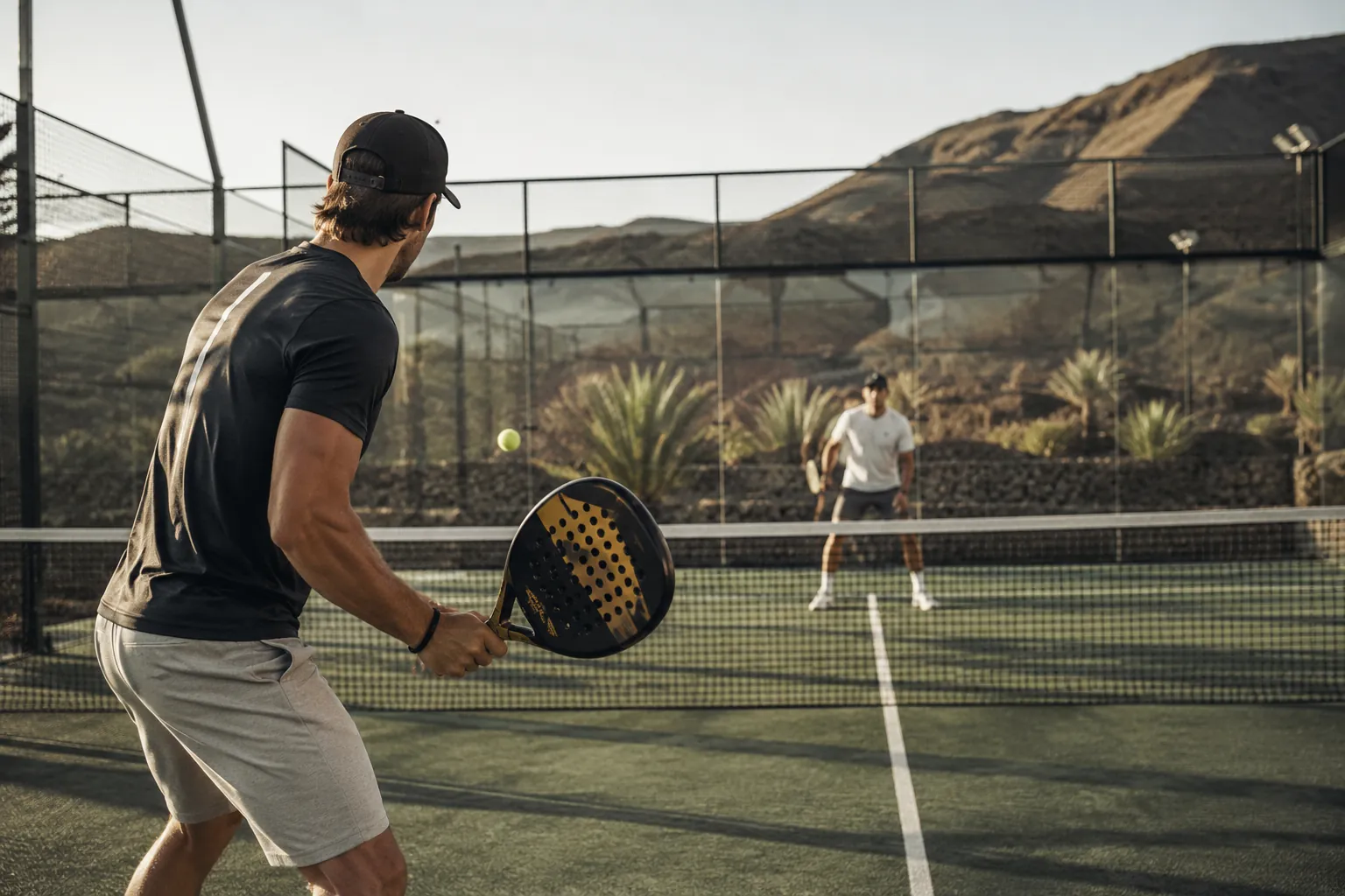 Padel match on a Lanzarote court with volcanic scenery in the background